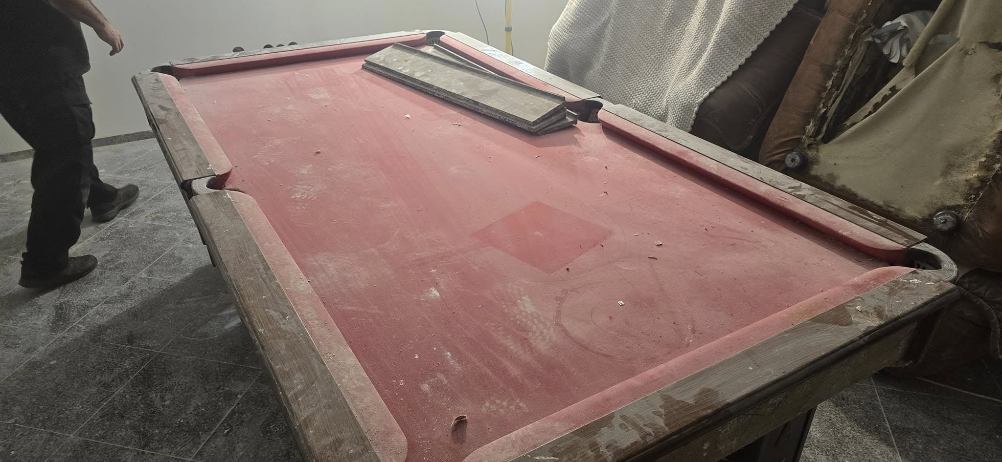 Mesa de bilhar parada há anos, coberta de pó e com pano descolorido